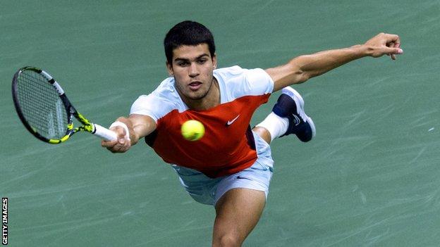 Carlos Alcaraz stretches for a ball in his US Open semi-final against Frances Tiafoe