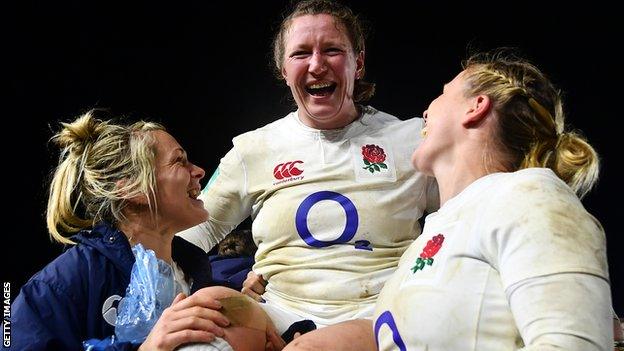 England's players lifted Rochelle Clark in tribute after the win