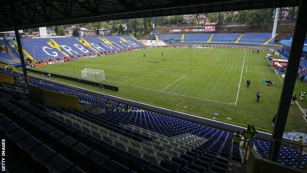 The game will be played behind closed doors at the Grbavica Stadium in Sarajevo