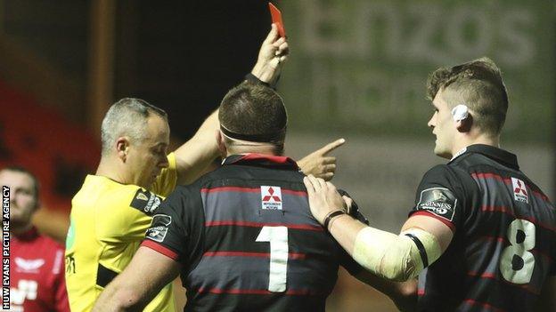 Referee John Clancy shows Michele Rizzo the red card