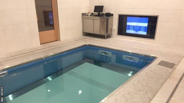 The underwater treadmill allows the runner to watch a TV displaying their foot strike