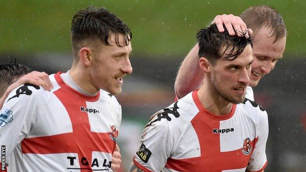 Declan Caddell is congratulated by Crusaders team-mates after opening the scoring at the Oval