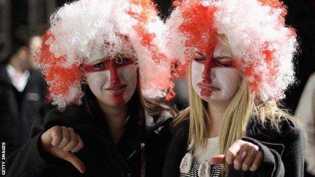 Disappointed England fans watch on