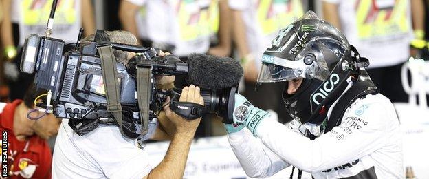 Nico rosberg looks into a TV camera lens