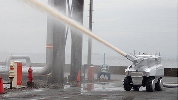 Robot water cannon truck firing jet of water