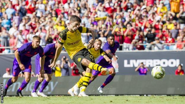 Borussia Dortmund's Christian Pulisic scores his first goal from a penalty