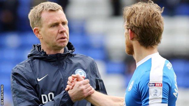 David Oldfield (left) shakes hands with a Peterborough player