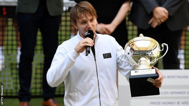 Alexander Bublik talks to the crowd after collecting the Halle Open trophy