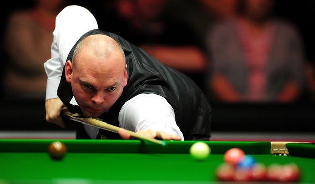 Stuart Bingham of England plays a shot against Ding Junhui of China during Day One of the Dafabet Masters