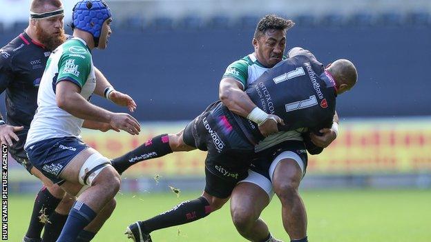 Ospreys wing Eli Walker is tackled by Bundee Aki of Connacht