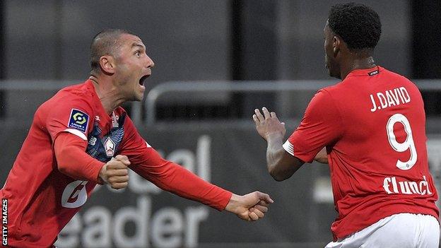 Jonathan David and Burak Yilmaz celebrate