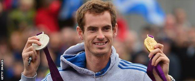 Murray shows off his singles gold and mixed doubles silver on a visit to his hometown of Dunblane