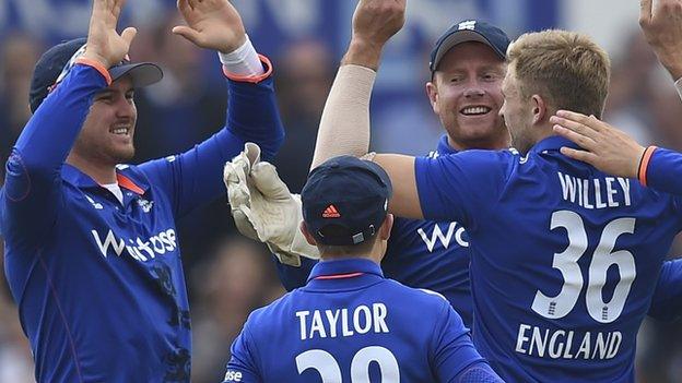 England celebrate a wicket by David Willey (right)