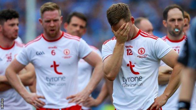 Tyrone players show their dejection on the pitch after the game