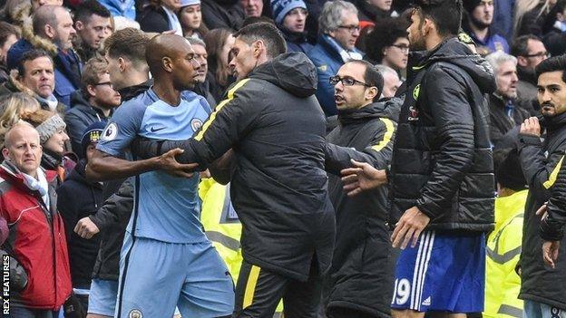 Fernandinho has to be restrained