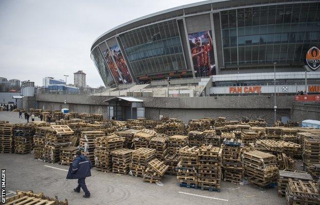 Shakthar stadium - pallets from aid packages stacked outside the ground