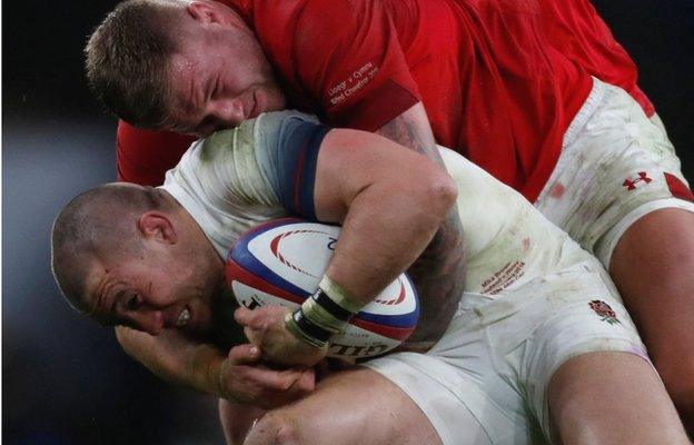 Mike Brown is tackled by Wales' Ross Moriarty