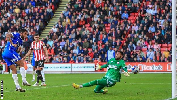 Troy Deeney scores against Sheffield United