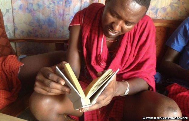 A man leafing through the book