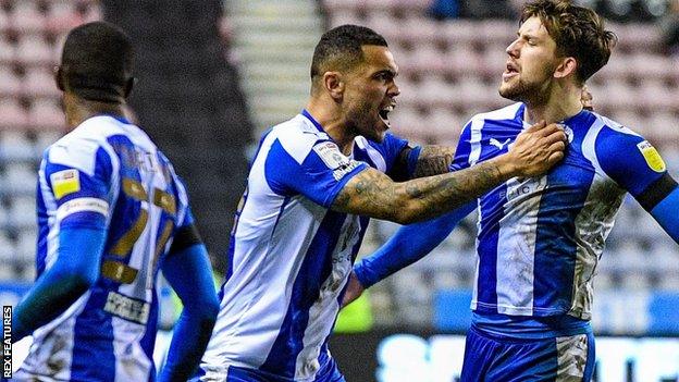 Callum Lang celebrates Wigan's first goal against Crewe