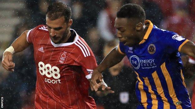 Nottingham Forest's Apostolos Vellios and Shrewsbury Town's Ebou Adams (right) battle for the ball