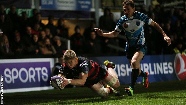 Aaron Wainwright dives over for a try as the with an Enisei defender trailing behind