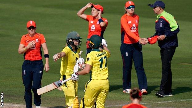 Ellyse Perry and Meg Lanning celebrate after Australia beat England