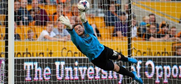 Newport goalkeeper Joe Day makes a diving save during the League Cup first-round match with Wolverhampton Wanderers