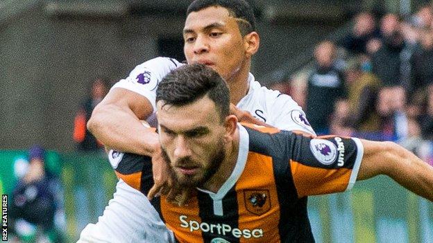 Hull's Robert Snodgrass holds off Jefferson Montero of Swansea City