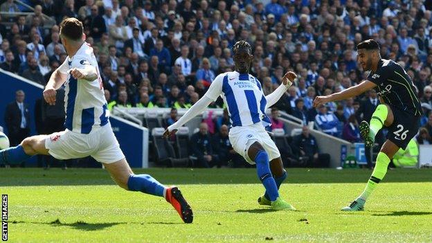 Riyad Mahrez scores Manchester City's third goal against Brighton