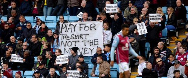 Villa fans hold up banners