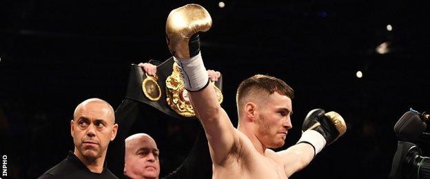 Ryan Burnett celebrates his victory as his trainer Adam Booth (left) looks to his right