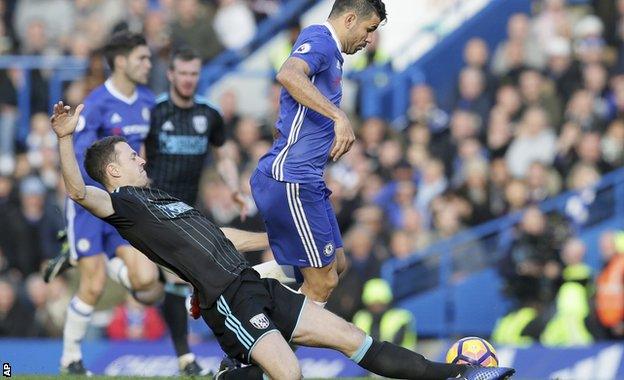 Jonny Evans challenges Diego Costa