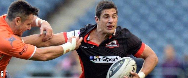 Phil Burleigh holds off a Newcastle tackler in Edinburgh's pre-season match