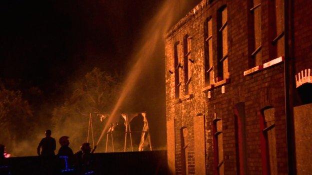 Firefighters sprayed water on nearby homes to protect them from heat damage