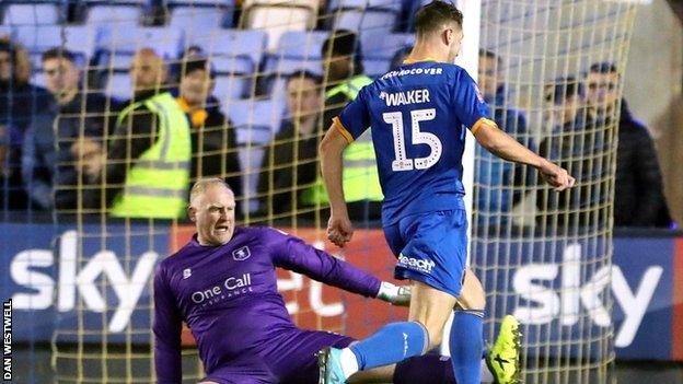 Brad Walker rounded Mansfield keeper Conrad Logan to score Shrewsbury's 94th-minute clincher