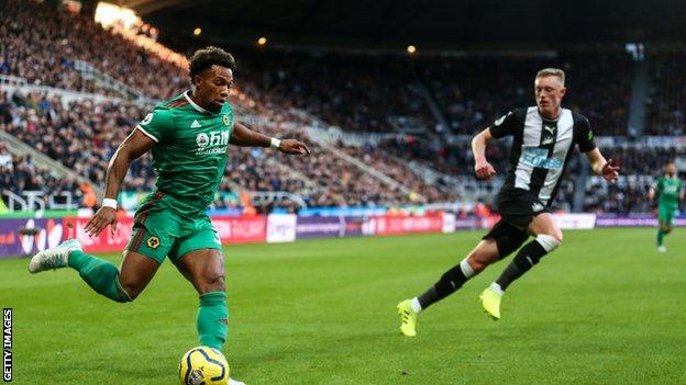 Adama Traore crosses the ball playing for Wolves against Newcastle