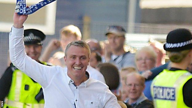 Lee Clark celebrates Kilmarnock's third goal by running down the touchline and grabbing a scarf