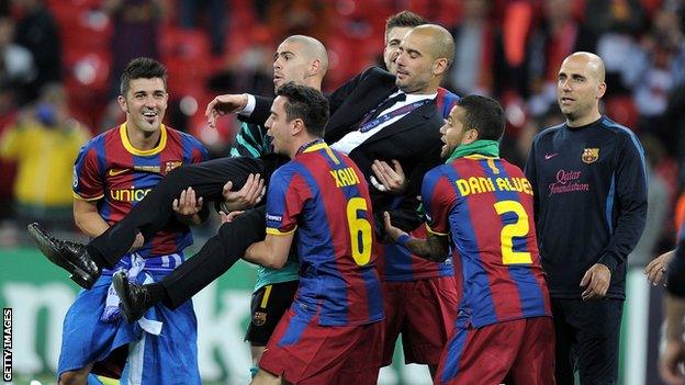 David Villa and his Barcelona team-mates lift coach Pep Guardiola after winning the 2011 Champions League final