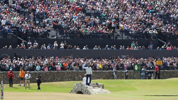 Tiger Woods crossing the Swilcan Bridge on the 18th hole at St Andrews