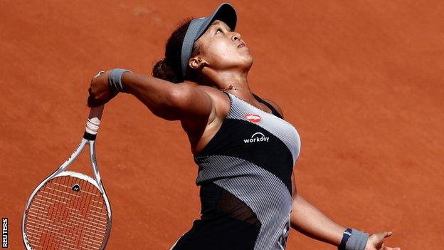 Naomi Osaka serves at the French Open