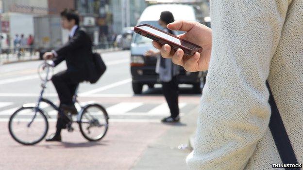 Man using mobile phone on street in Tokyo, Japan