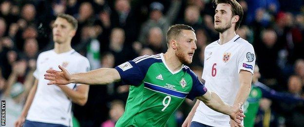 Conor Washington celebrates after netting his third international goal in the 32nd minute