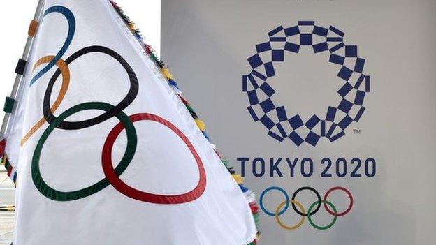 An Olympic flag and the logo of the Tokyo 2020 Games