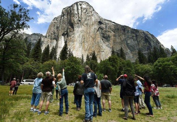 Visitors look up at the El Capitan monolith in the Yosemite National Park in California