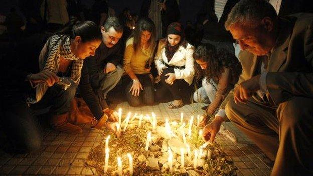 Lebanese leftists light candles in front of the electricity authority in Beirut on November 23, 2009 during a protest against power cuts