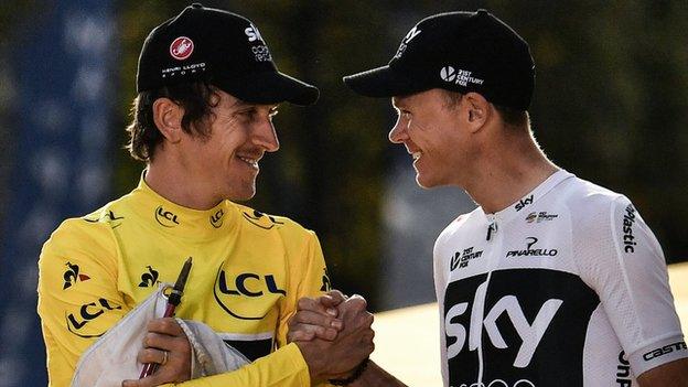 Tour de France champion Geraint Thomas and Chris Froome clasp hands in celebration on the podium in Paris