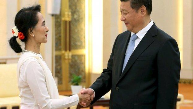 China's President Xi shakes hands with Aung San Suu Kyi during meeting at Great Hall of People in Beijing