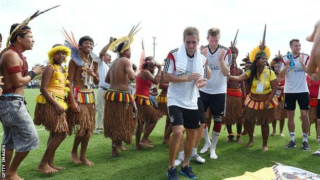 Philipp Lahm dances with indigenous Brazilian people after the German training session at Campo Bahia on 9 June 2014