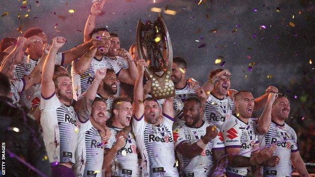 Storm captain Cameron Smith lifts the NRL trophy